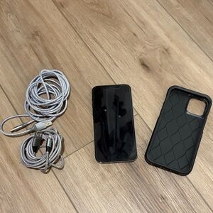 Apple IPhone 12 Pro Smartphone with Silver Cables and Black Case